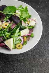 Salad with olives, cheese and green leaves fresh delicious gourmet food background on the table rustic food top view copy space keto and paleo diet vegetarian  food