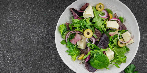 Salad with olives, cheese and green leaves fresh delicious gourmet food background on the table rustic food top view copy space keto and paleo diet vegetarian  food