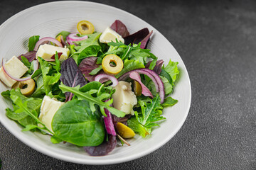 Salad with olives, cheese and green leaves fresh delicious gourmet food background on the table rustic food top view copy space keto and paleo diet vegetarian  food