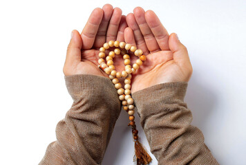 Hands holding prayer beads iconic