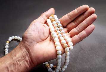 Hands holding prayer beads