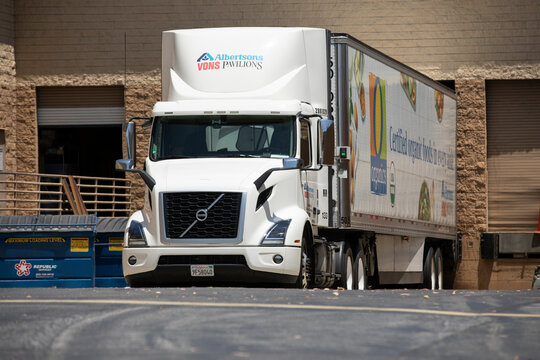 Fullerton, California, USA - June 17, 2022: An Albertsons Vons Pavillions branded semi truck unloads its cargo at a receiving dock.