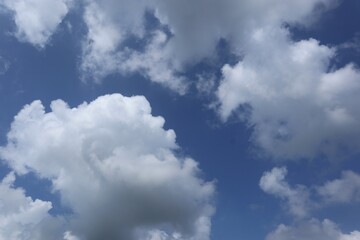 Expansive Blue Sky Canvas Adorned with Pillowy Cumulus Clouds on a Sunny Day