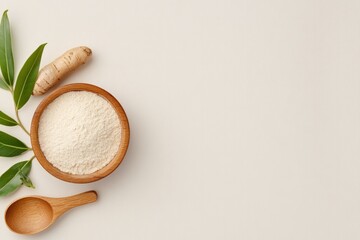 Top view of ashwagandha powder, root and wooden spoon on the left on beige background, copy space for text. Concept Medicinal Herb, superfood, Ayurveda and alternative medicine