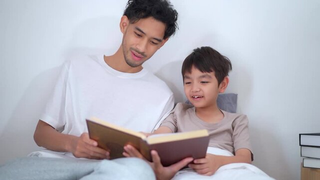 Asian man let his son learn about the holy koran.