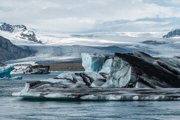 The stunning J&ouml;kuls&aacute;rl&oacute;n Lagoon in Iceland is home to massive icebergs, their blue hues contrasting beautifully against the cold, clear water