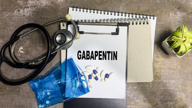 Concept of Gabapentin write on paperwork isolated on Wooden Table. - Powered by Adobe