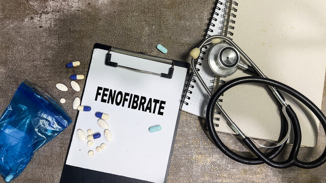 Concept of Fenofibrate write on paperwork isolated on Wooden Table.