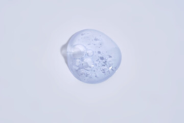 A drop of blue serum with bubbles.