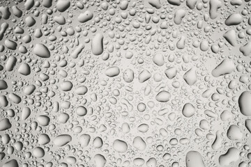 Water drops on grey glass surface, top view