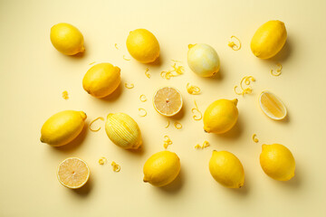 Lemon zest and fresh fruits on beige background, flat lay