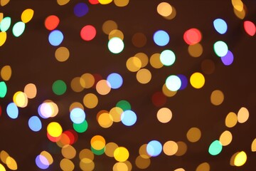Blurred view of colorful lights on dark background, bokeh effect