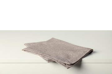 Gray napkin on light table against white background