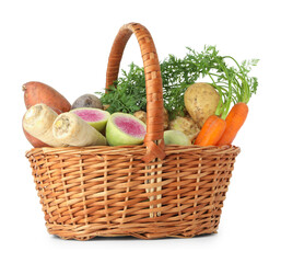 Different root vegetables in wicker basket isolated on white