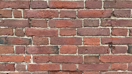 A photo of the texture of a hand-molded red brick wall. An old brick wall in an old castle.