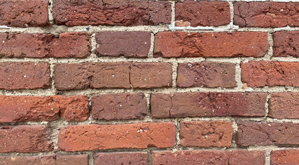 The brick wall is made of red brick. The destruction of the facade of the building. Antique brickwork.