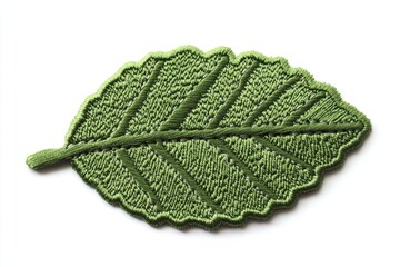 Green embroidered leaf patch on white background