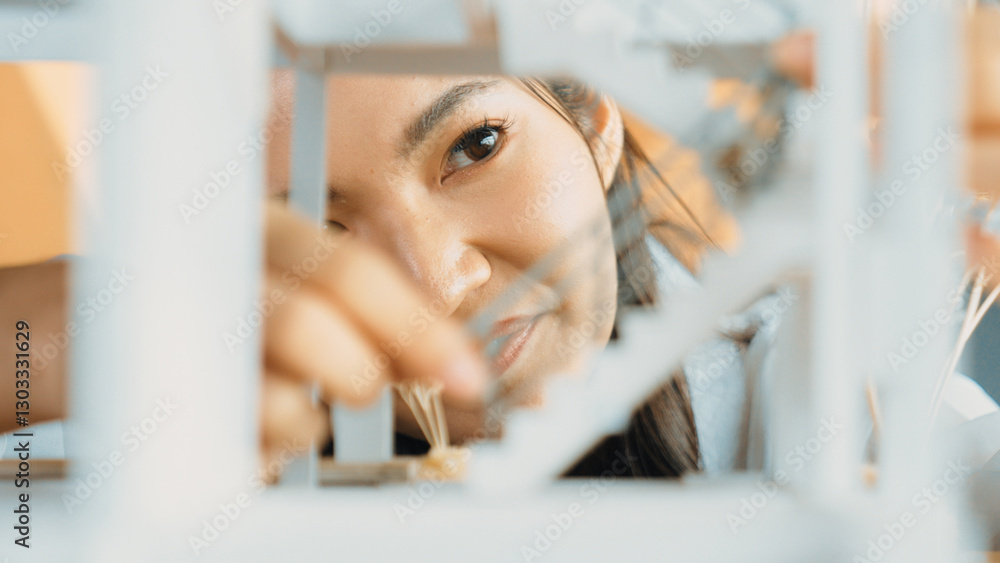 Poster closeup portrait of architect engineer face reviewing house model while inspect building constructio