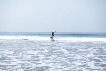 Fototapeta premium A man on a vacation surfs on a board in the ocean