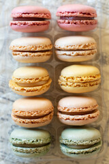 Fototapeta premium French macarons in pastel rainbow colors top view
