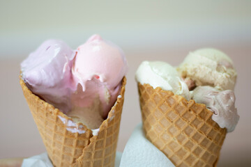 A couple of dairy ice creams melting in biscuit cones