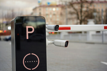 Advanced monitoring cameras mounted on parking gate for enhanced security and safety.Electronic...