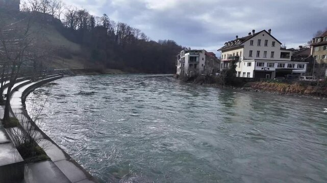 Serene winter river scene in Bern with charming houses