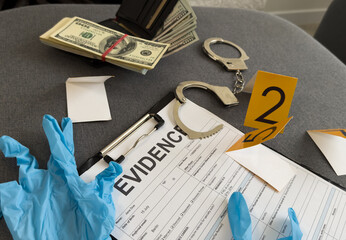 Money, handcuffs and fingerprint record sheets on wooden background, top view with space for text....
