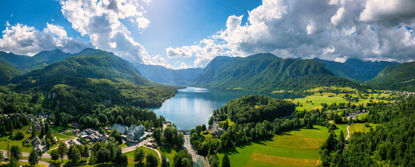 Aerial view of Bohinj lake in Julian Alps. Popular touristic destination in Slovenia. Bohinj Lake, Church of St John the Baptist. Triglav National Park, Julian Alps, Slovenia.
