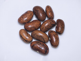 Brown pinto beans on a white background close -up.