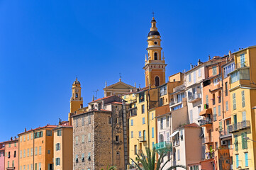 Fototapeta premium Church towers and old buildings in Menton, France, summer season