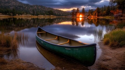 Obraz premium Serene Sunset Canoe on Calm Lake
