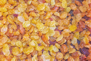 Golden raisins spread out on a surface displaying their natural color and texture in a kitchen setting