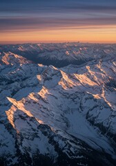 Obraz premium A glorious sunrise over a majestic snow-covered mountain range, seen from the sky.