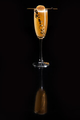 Orange cocktail on a black background.