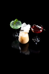 Various alcoholic cocktails on a black background.