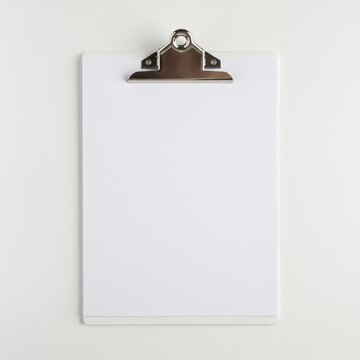 Blank Clipboard on White Background - A clean, white clipboard with a silver clip, isolated on a white background. Perfect for mockups and presentations