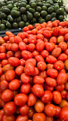 colorful arrangement of fresh, ripe red tomatoes stacked together, showcasing their natural texture and vibrancy, perfect for culinary, market, or agricultural themes.