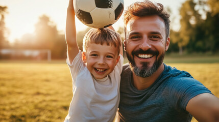 A man and a boy are smiling and holding a soccer ball