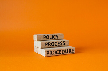 Policy Process Procedure symbol. Concept words Policy Process Procedure on wooden blocks. Beautiful orange background. Business concept and Policy Process Procedure. Copy space.