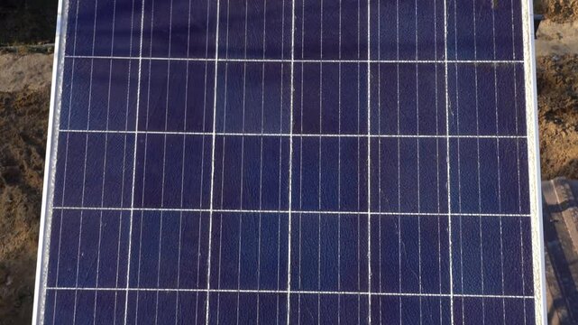 Solar panel with hole and crack on a bright sunny day. 