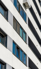 Modern high-rise building with a sleek concrete facade in a developing metropolitan neighborhood....
