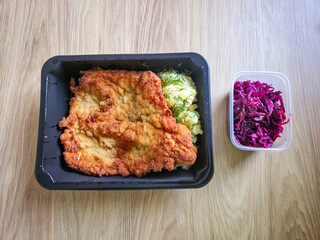 Pork chop with mashed potatoes and red sauerkraut.