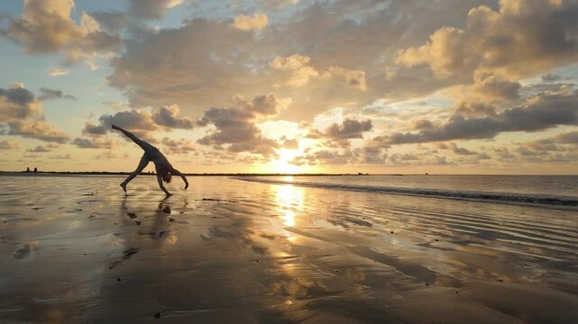 Man does Roundoff Backflip in front of stunning Sunset in slow motion 