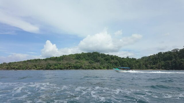 Ferry boat flying down the Pacific coast in Costa Rica near Drake's Bay, Slow motion