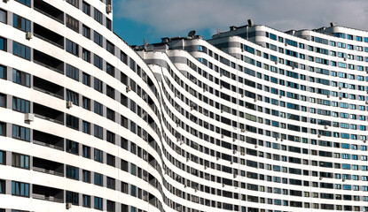 Modern high-rise condominium with a wavy, curved shape in a metropolitan city. Unique architecture,...