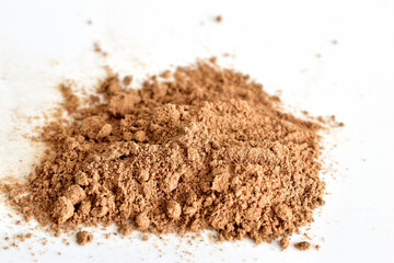 Dry, ground and aromatic spice cinnamon lies on a white background.