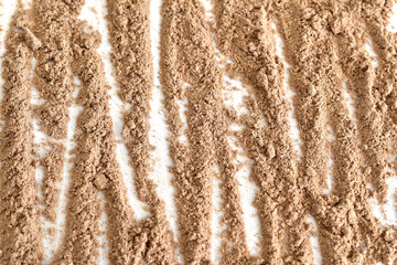 Dry, ground and aromatic spice cinnamon lies on a white background.
