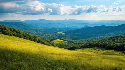 Fototapeta premium Mountain valley vista with wind turbines