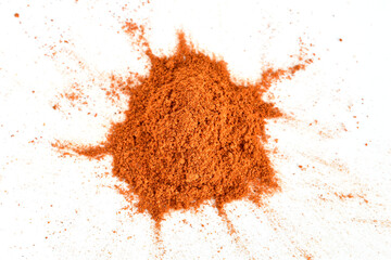 Dry and ground red pepper lies on a white background.